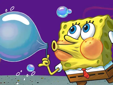 SpongeBob SquarePants, a yellow sponge with blue eyes, a white shirt, red tie, and brown pants, blows a bubble out of bubble soap.